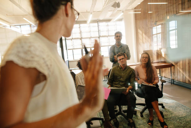 istock Female executive discussing ideas with colleagues 660322394