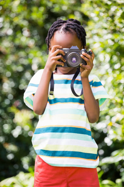 istock Portrait of boy taking pictures 660325568