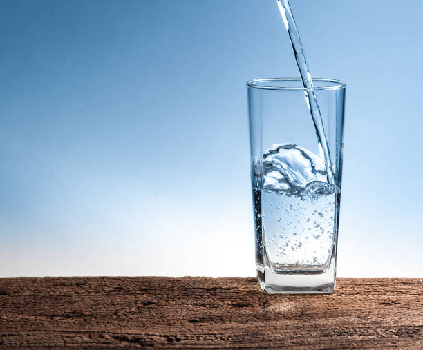 istock Pouring water on glass on wood 660325950