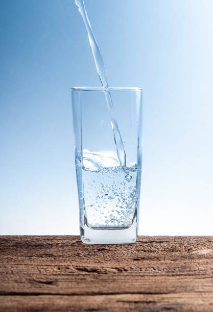 istock Pouring water on glass on wood 660326000