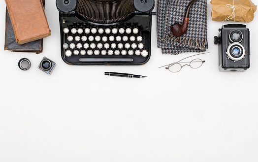 Top view of white isolated items of an old journalists desk. Thirties, forties or fifties journalism theme on white background with copy space.