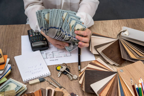 istock Man holds money for building design 660329058