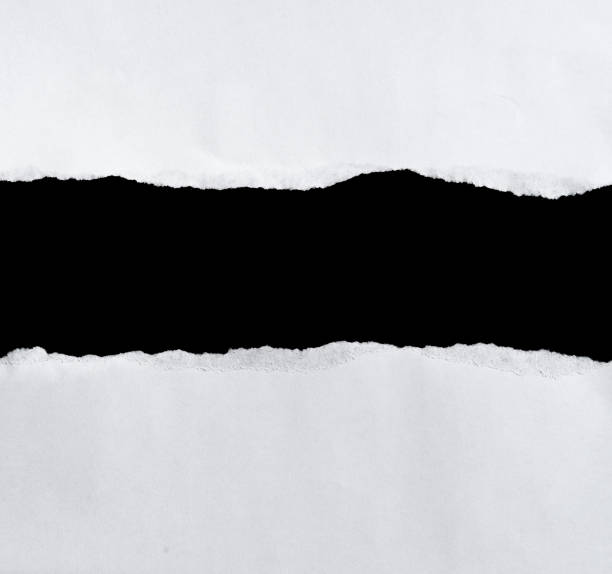 istock White torn of paper isolated on a black background. 660329078