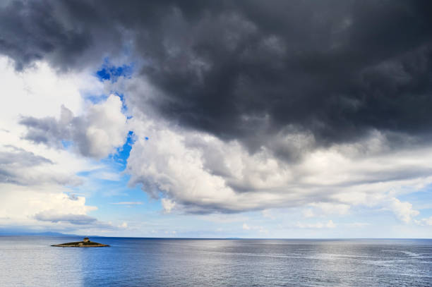 istock Island with lighthouse in the sea 660340802