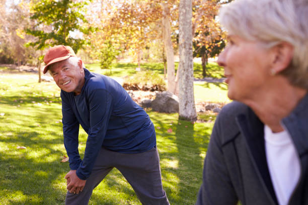 istock Senior Couple Stretching Whilst Exercising Together In Park 660353238