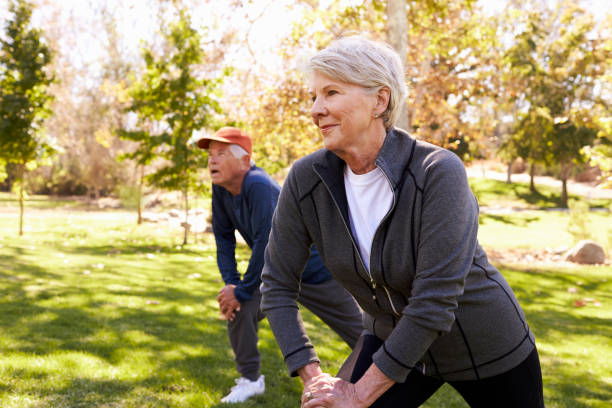 istock Senior Couple Stretching Whilst Exercising Together In Park 660353248