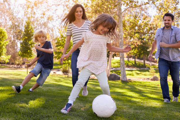istock Family Playing Soccer In Park Together 660353368