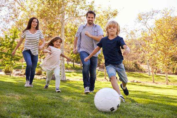 istock Family Playing Soccer In Park Together 660353408
