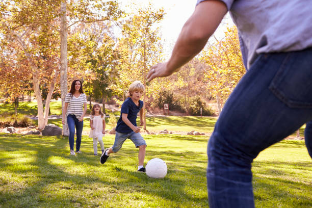 istock Family Playing Soccer In Park Together 660353410