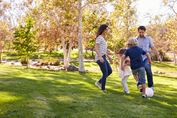 istock Family Playing Soccer In Park Together 660353422