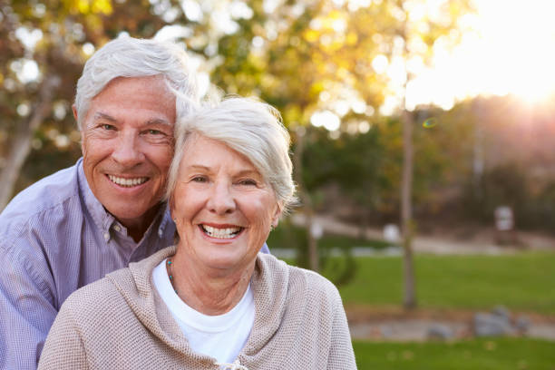 Romantic Senior Couple Shot Against Sun In Park