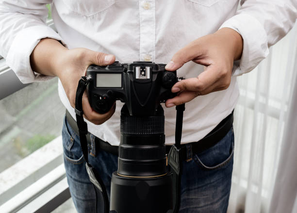 istock professional photographer adjusts the camera before shooting 660355714