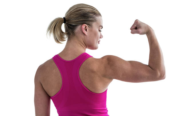 istock Rear view of muscular woman flexing muscles 660359610