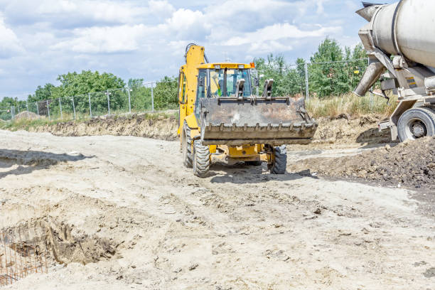 istock Excavator is carry bucket filled with fresh concrete 660360246