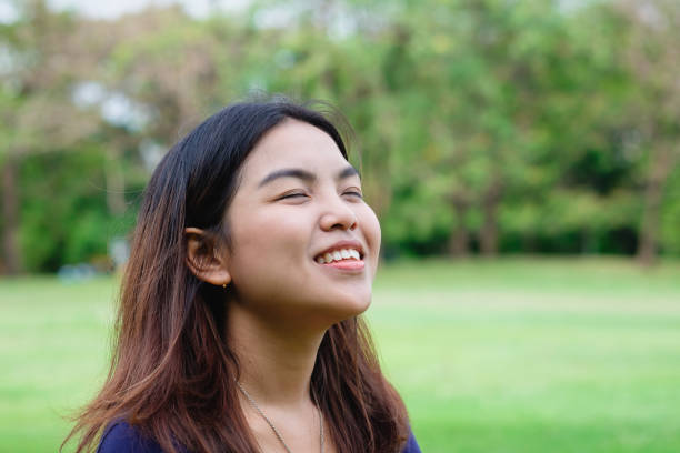 istock Young happy woman in green field 660373398