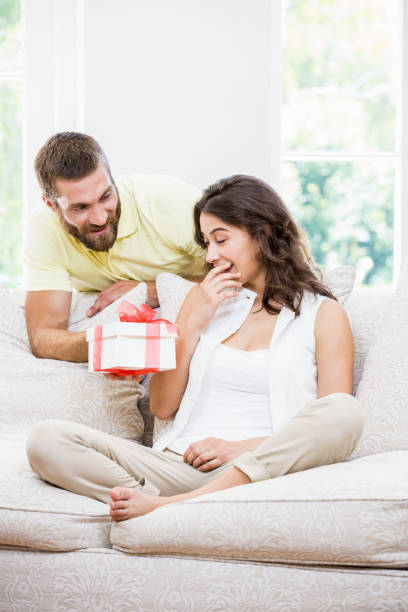 istock Man giving a surprise gift to her woman 660374042