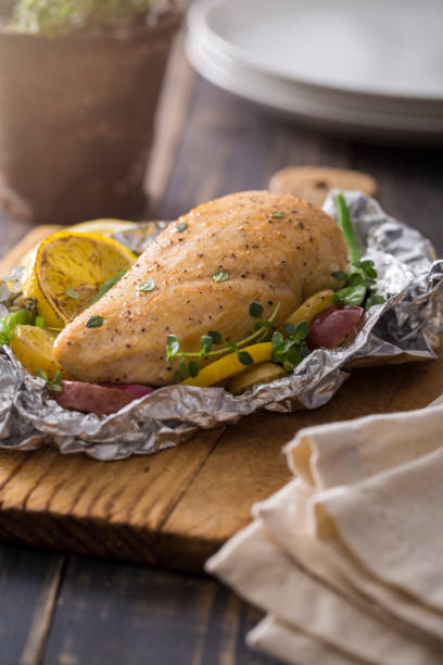 istock Grilled Chicken with Vegetables in Foil Pouch 660374378