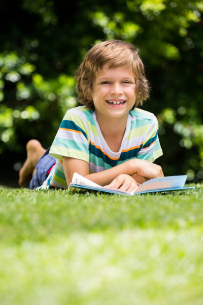 istock A little boy is lying down in the grass 660377810