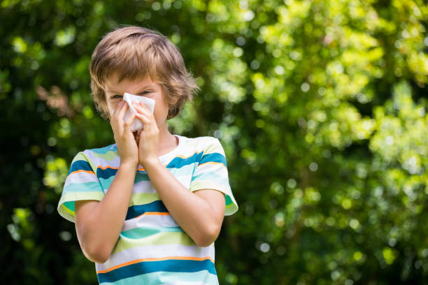 istock A little boy is blowing ones nose 660379440