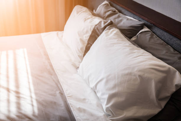 istock Bed maid-up with clean white pillows and bed sheets 660385010