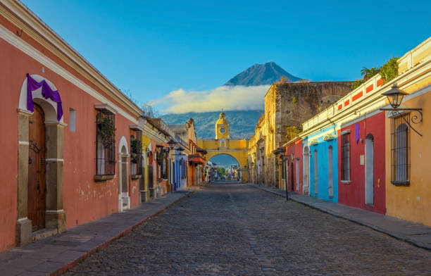 Antigua City at Sunrise The historic city of Antigua at sunrise with a view over the main street and the Catalina arch and the Agua volcano in the background, Guatemala. agua volcano photos stock pictures, royalty-free photos & images