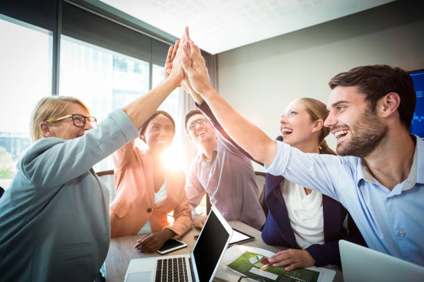 istock Business people giving high five at desk 660386230