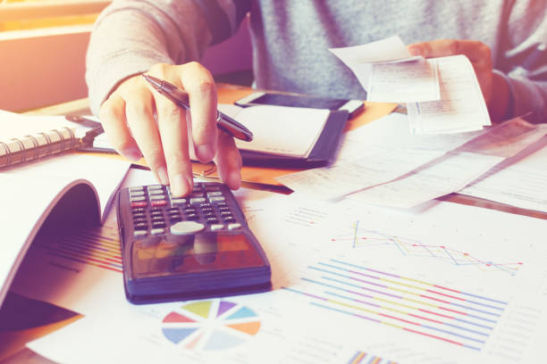 istock Man using calculator and calculate cost with holding bill. 660390852