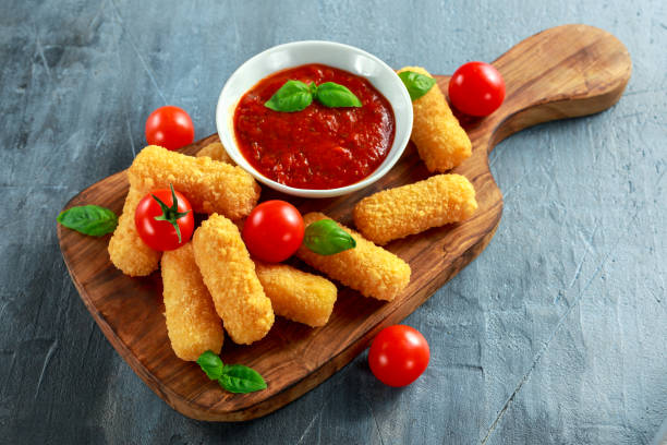 istock Breaded mozzarella cheese sticks with tomato basil sauce 660391576