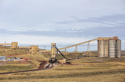 Cement silos at an industrial coal mining site in a spring Wyoming countryside landscape
