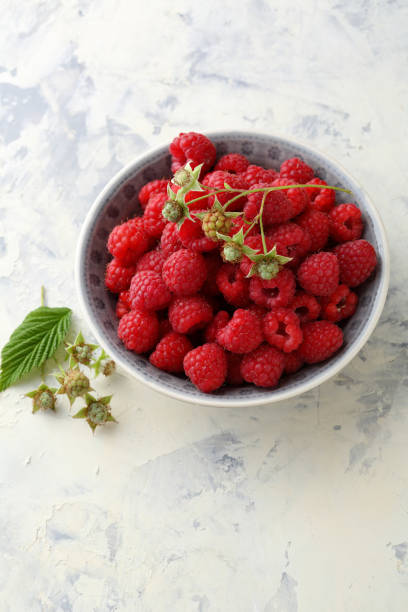 istock Fresh organic raspberry in small bowl, food closeup 660398778