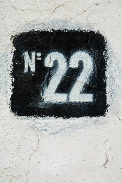 istock Stencilled number twenty two in black on white plaster wall 660399182
