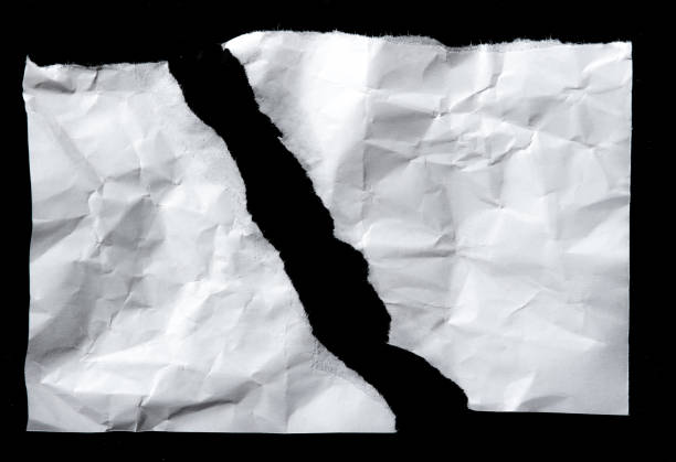 istock White torn of paper isolated on a black background. 660409830