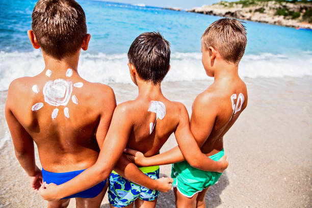 istock Boys with sun protection on the beach 660414978