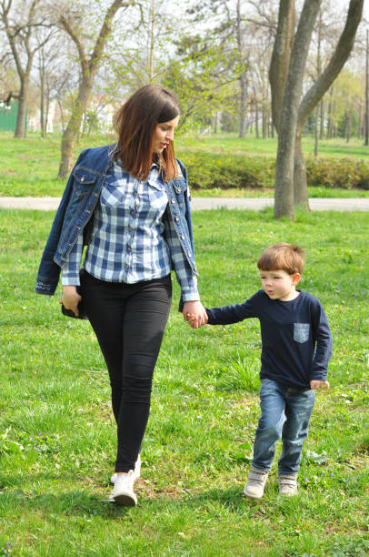 istock Happy mom and son play in the park in spring. 660415004