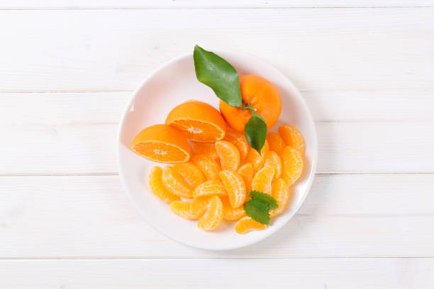 istock whole and sliced tangerines 660423074