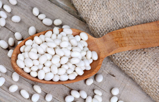 istock White beans in a wooden spoon 660425240