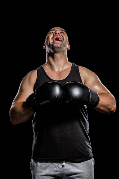istock Boxer in boxing gloves laughing 660429350