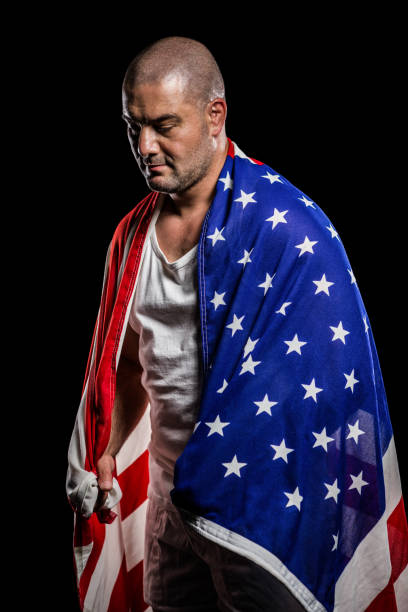 istock Athlete with england flag wrapped around his body 660434220
