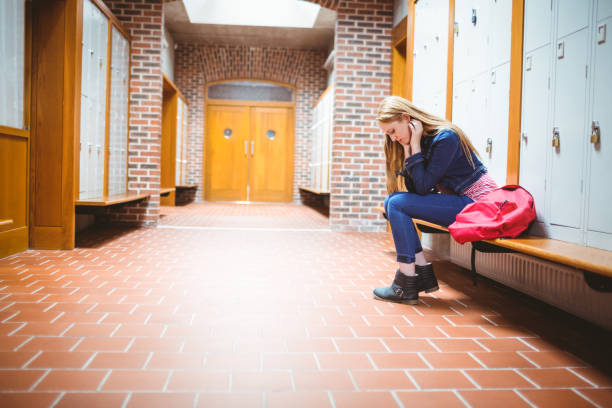 istock Worried student sitting and looking down 660439074