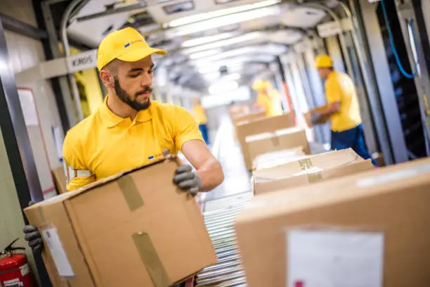 Photo of Man holding packed box