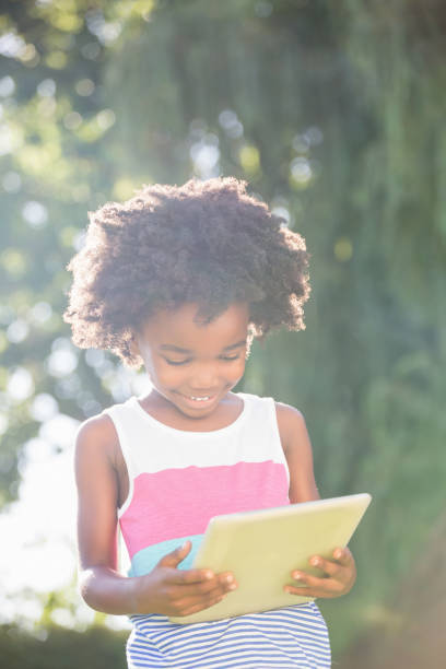 istock Portrait of cute boy holding and using a tablet 660453198