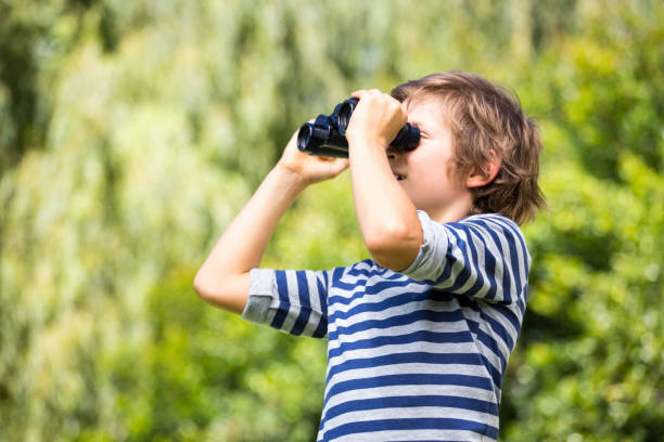 istock Portrait of cute boy looking something with binoculars 660453966