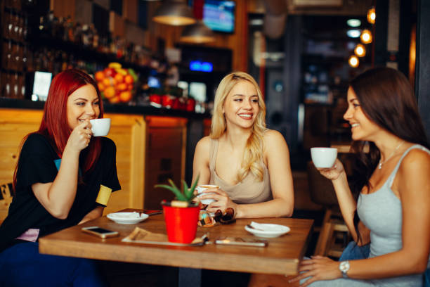 istock Gossip girls in a cafe drinking coffee 660455484