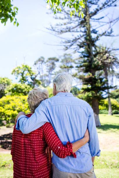 istock Senior couple embracing in park 660461178
