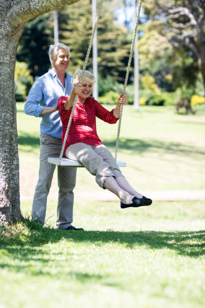 istock Senior man pushing his partner on swing 660461910