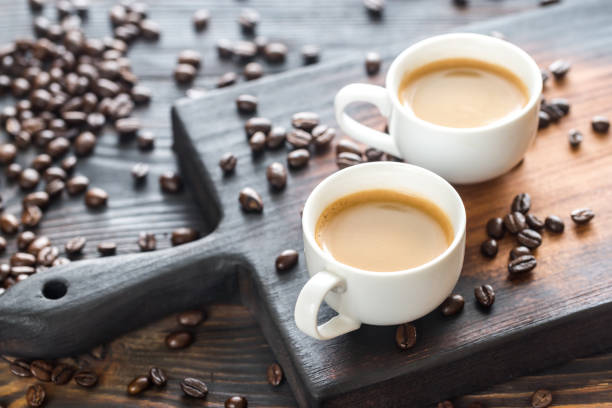istock Two cups of coffee with coffee beans 660462160