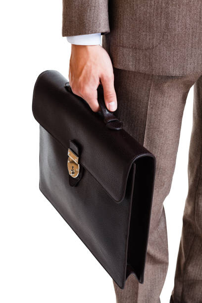 istock A man in a classic suit holds a brown briefcase 660462266