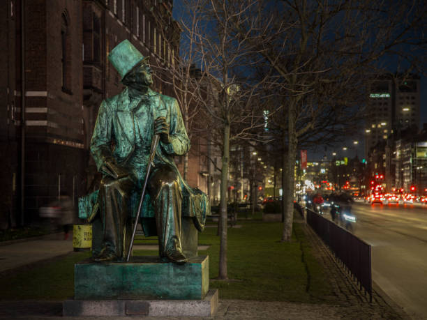 Hans Christian Andersen statue next to the Copenhagen Town Hall Hans Christian Andersen statue situated next to the Copenhagen Town Hall and overlooking the Hans Christian Andersen Castle, a venue in Tivoli. hans christian andersen stock pictures, royalty-free photos & images