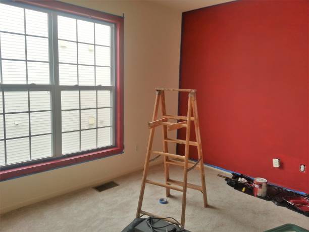 istock Interior renovation with ladder, and freshly painted red wall 660464984