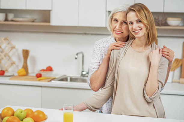 istock Cute mother and daughter hugging at home 660472156